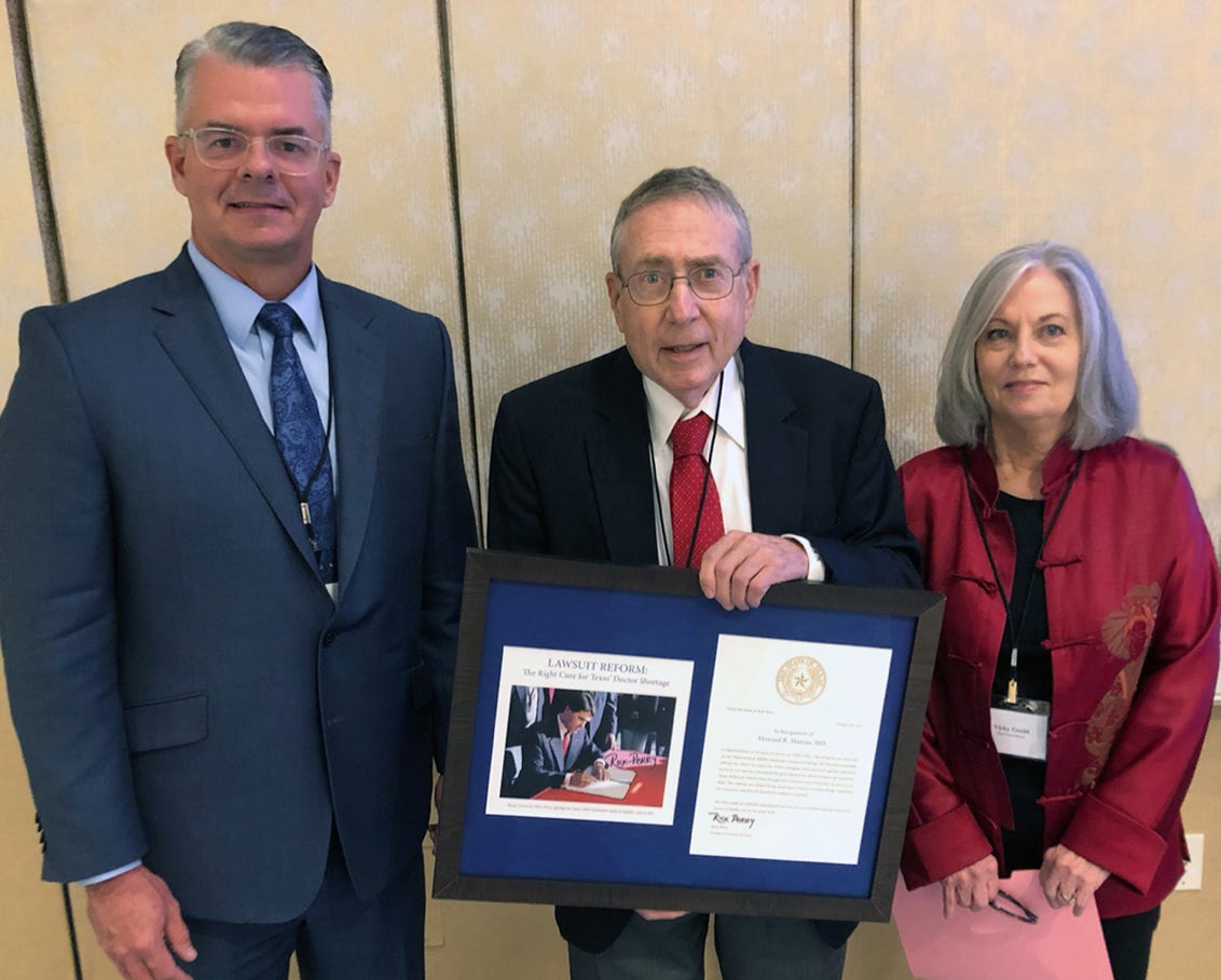 Howard Marcus awarded plaque for twenty years of service and success.